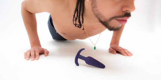 A man doing push up with anal sex toy